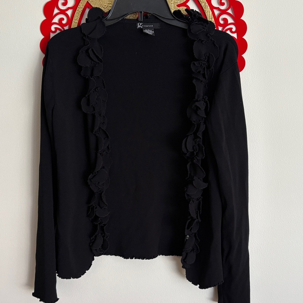 G Signature: Black Ruffled Cardigan with hidden buttons.